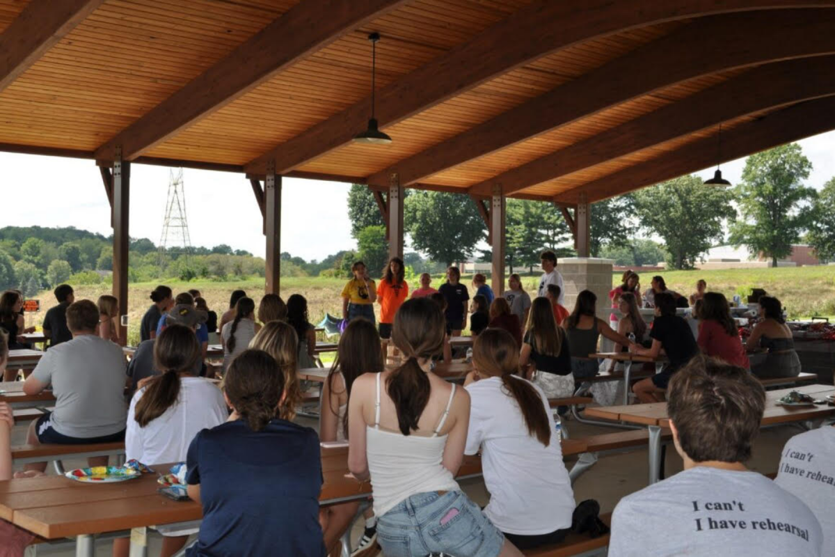 Thespians listen intently as officers announce the 2026 shows at the kickoff picnic at Peterswood Park on Sunday, August 24.